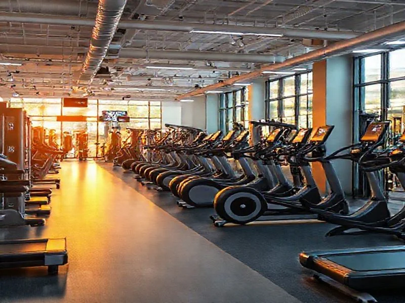 Abstract visualization of ergonomic design, showing glowing contours mapping to human joint movements and muscle groups on a translucent machine silhouette. No human figures.